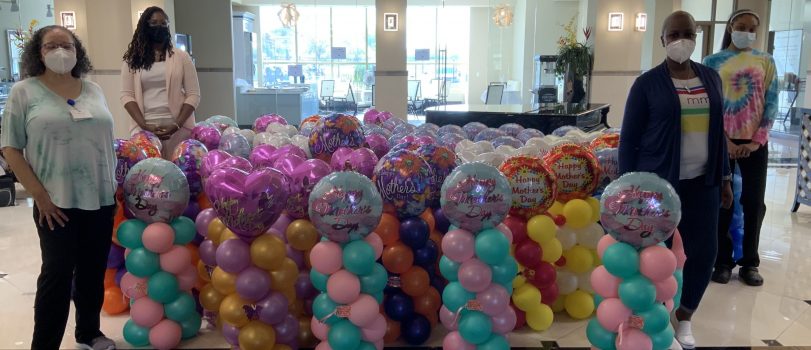 Staff from Windsor Estates Nursing & Rehabilitation receive balloons that were donated as part of the Mother's Day Card Project.